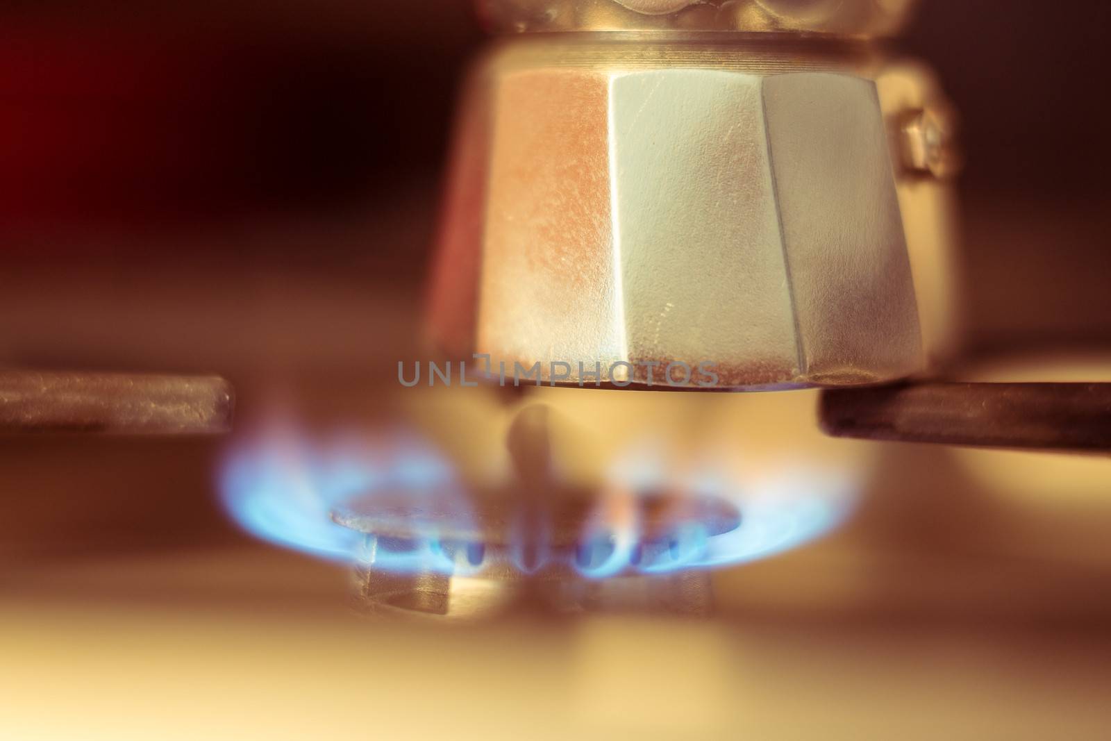 Close-up shot of Italian coffee maker on stove, artistic photo with shallow depth of field 