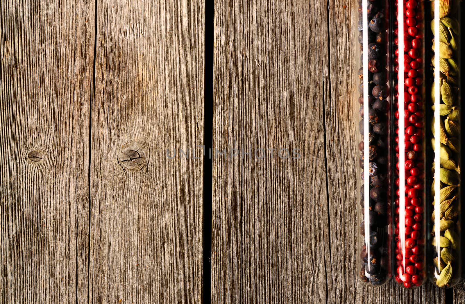 Spices in beakers on wooden background