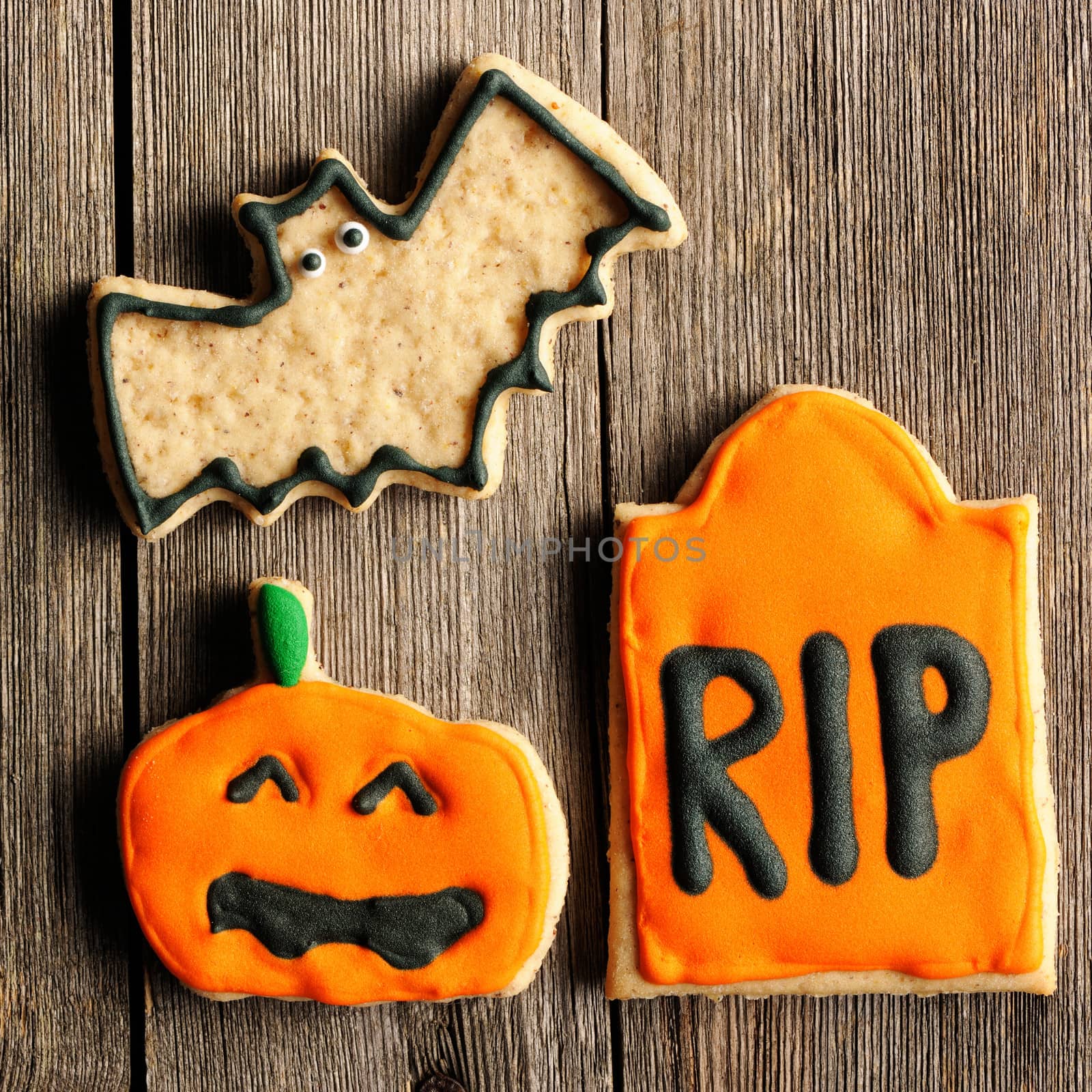 Halloween homemade gingerbread cookies over wooden table