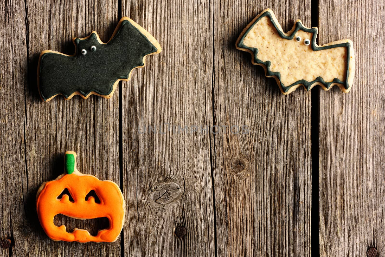 Halloween homemade gingerbread cookies over wooden table