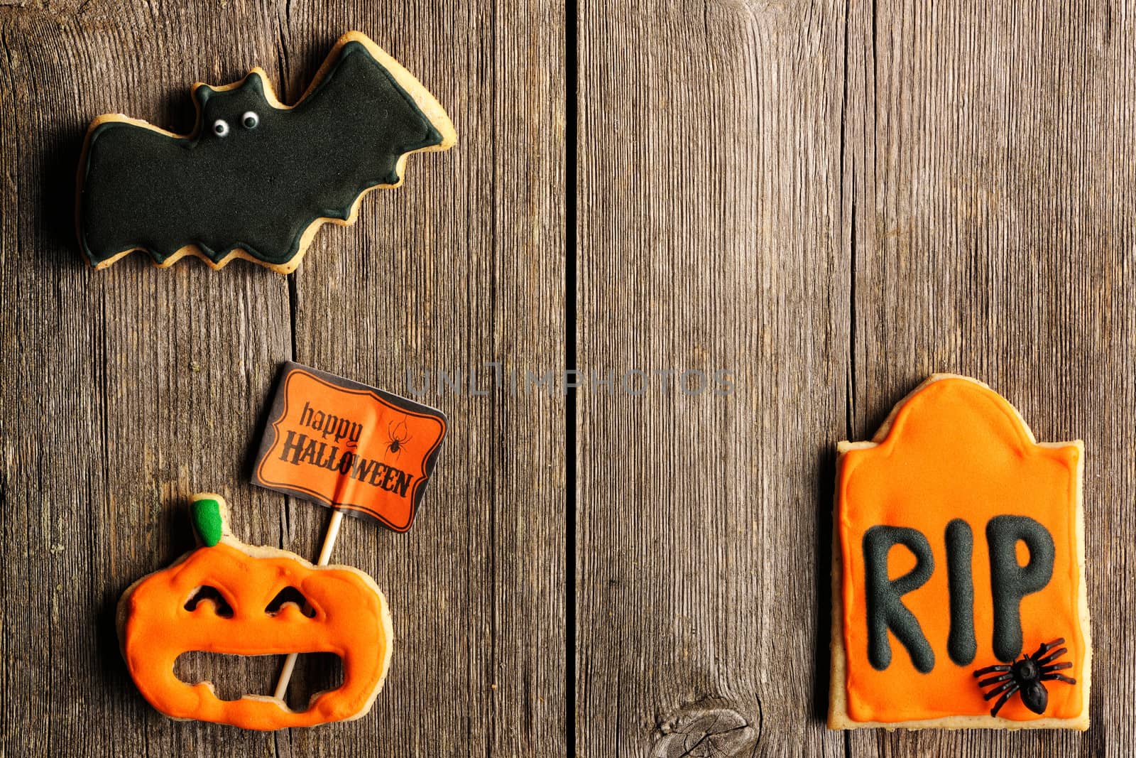 Halloween homemade gingerbread cookies over wooden table