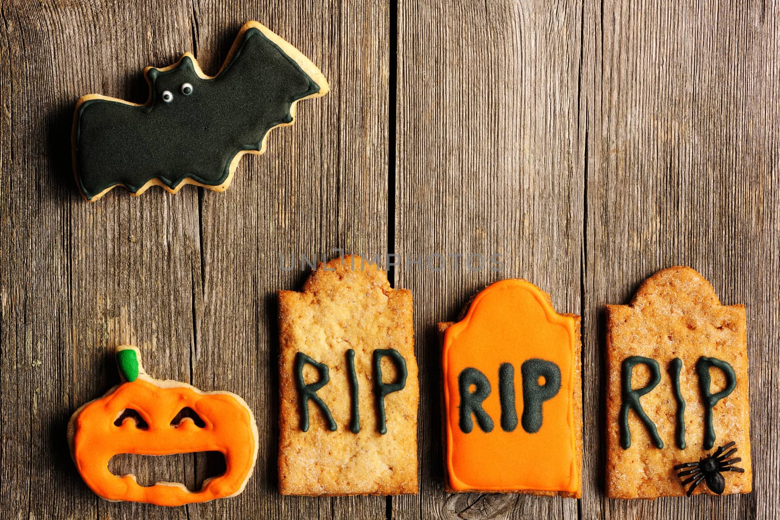 Halloween homemade gingerbread cookies over wooden table