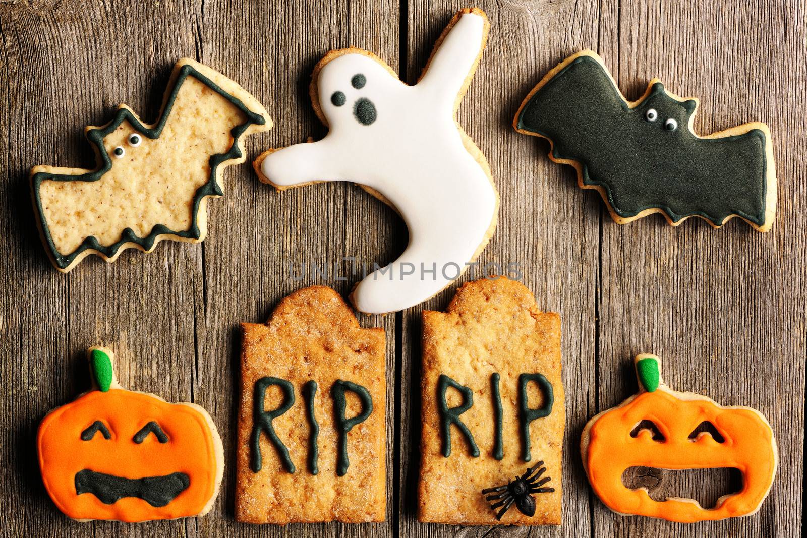 Halloween homemade gingerbread cookies over wooden table