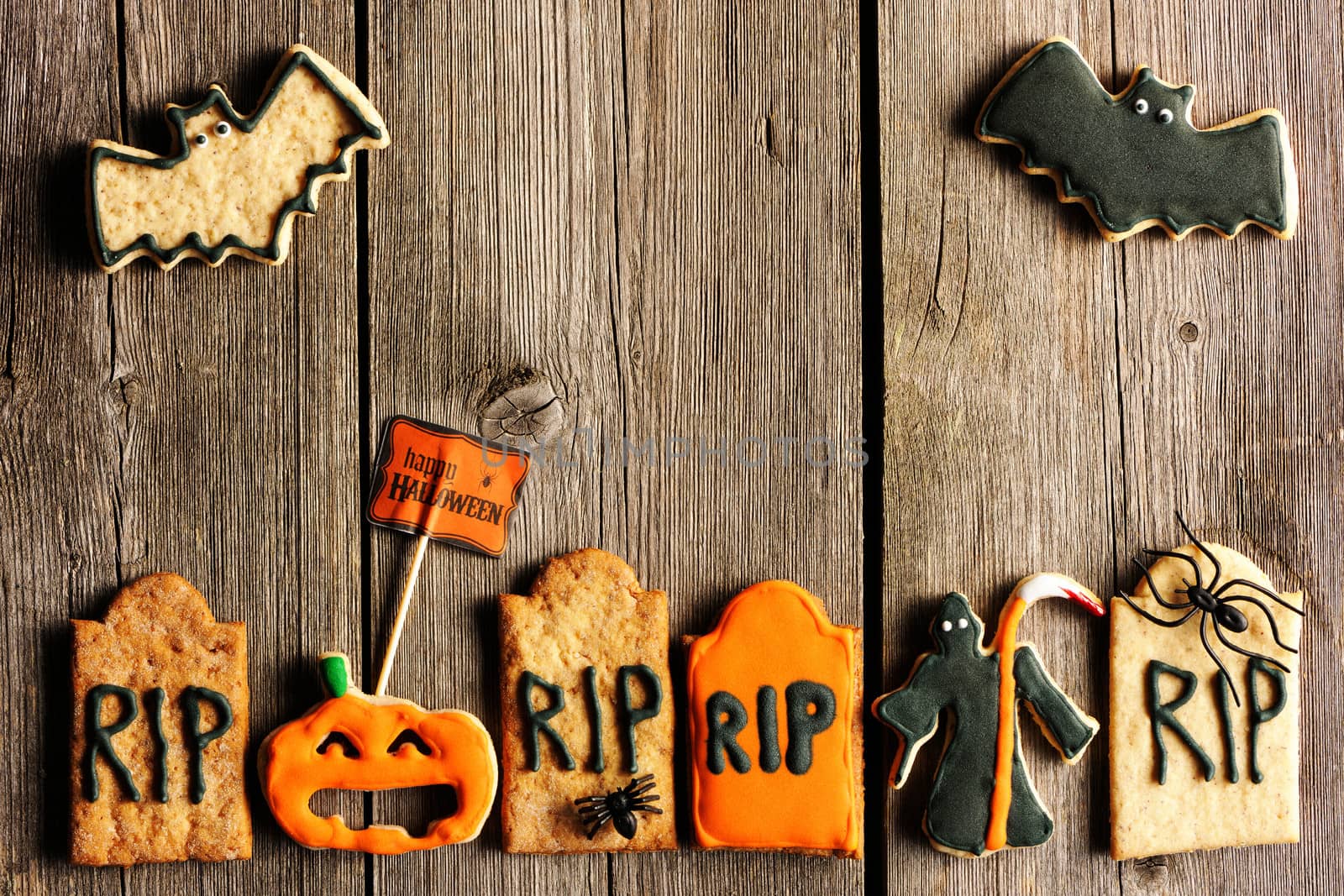 Halloween homemade gingerbread cookies over wooden table