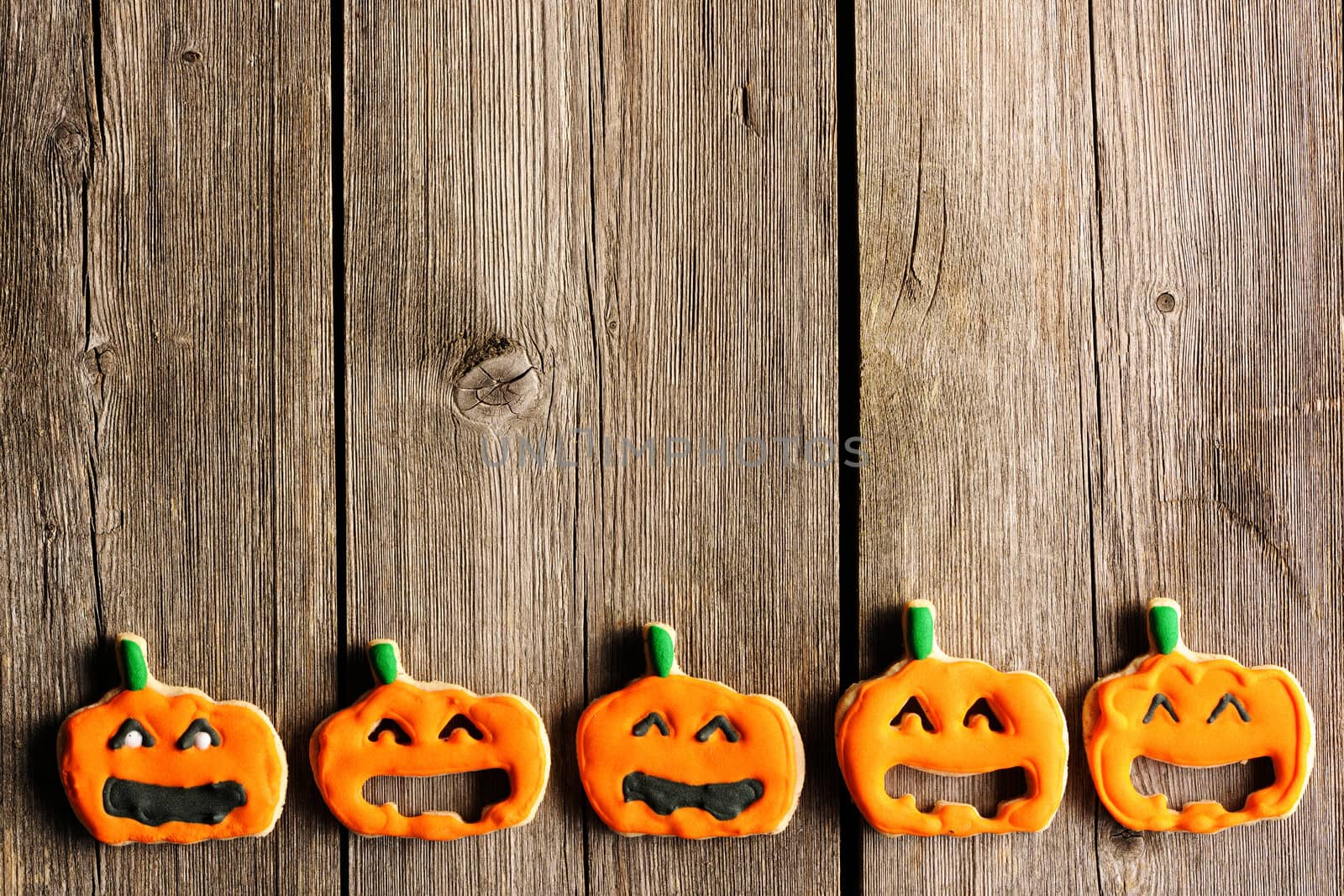 Halloween homemade gingerbread cookies over wooden table