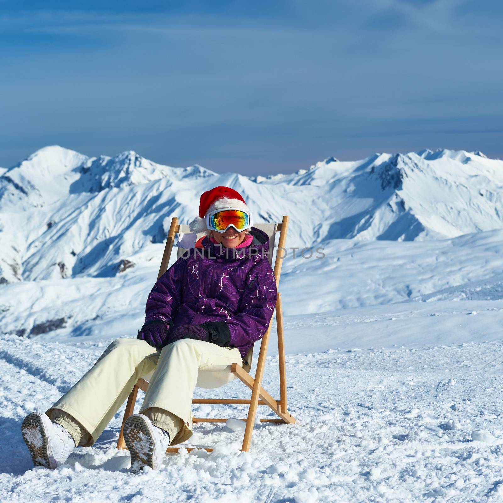 Woman at mountains in Santa hat celebrating christmas, Meribel, Alps, France