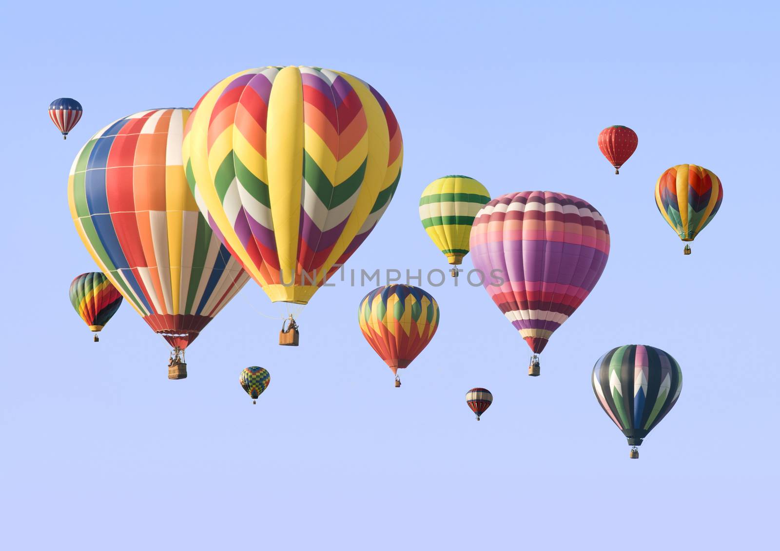A group of colorful hot-air balloons floating across the sky