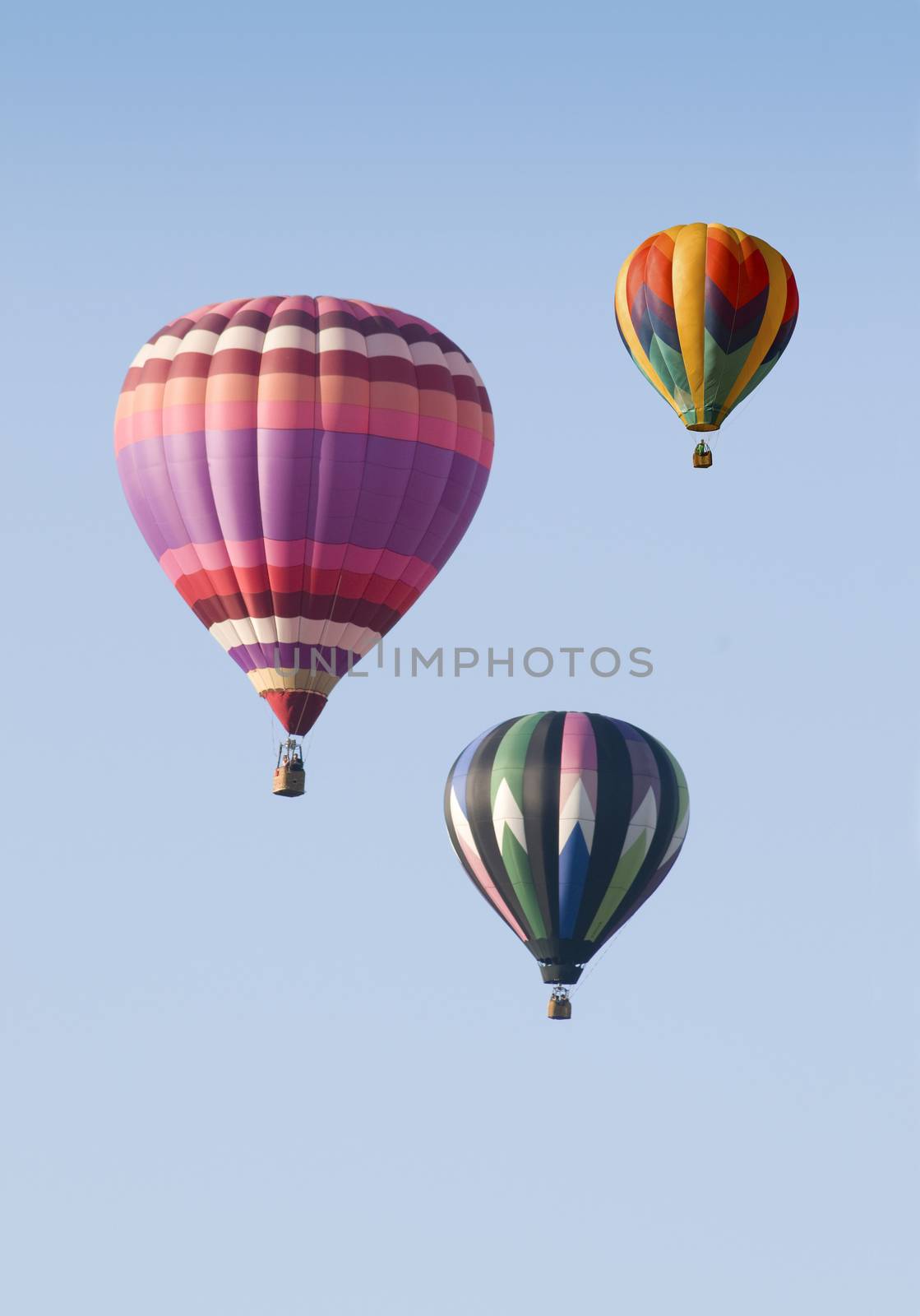 Three Hot-Air Balloons Floating against a Blue Sky by Balefire9