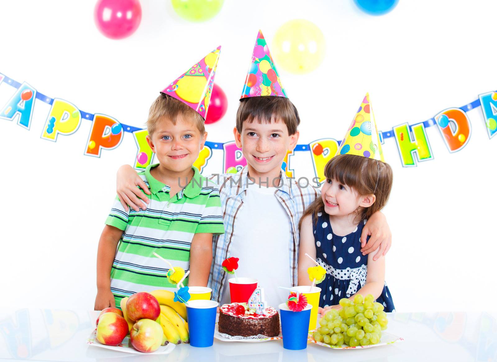 Three adorable kids having fun at birthday party