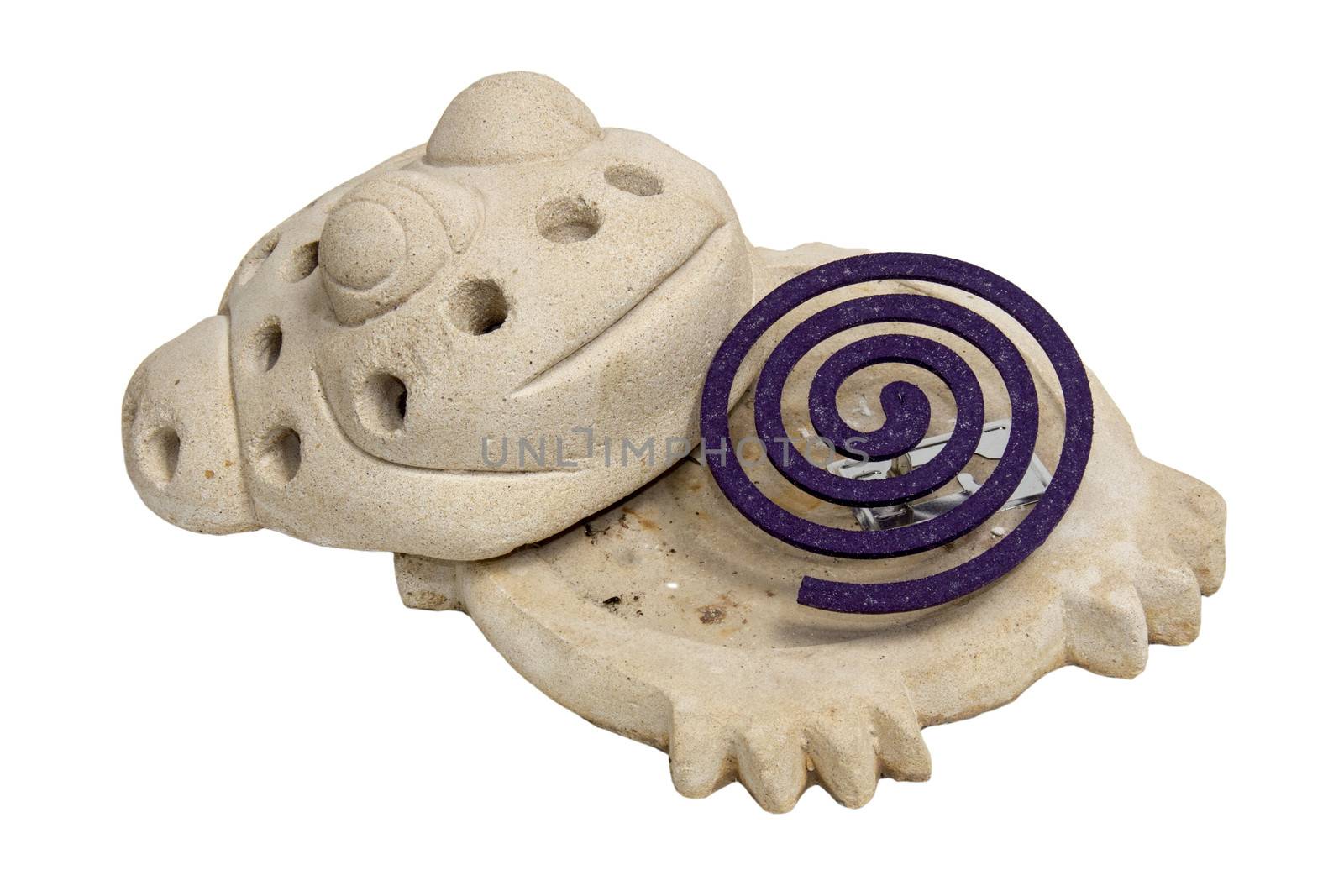 Purple coloured mosquito coil and frog shaped holder isolated on white background