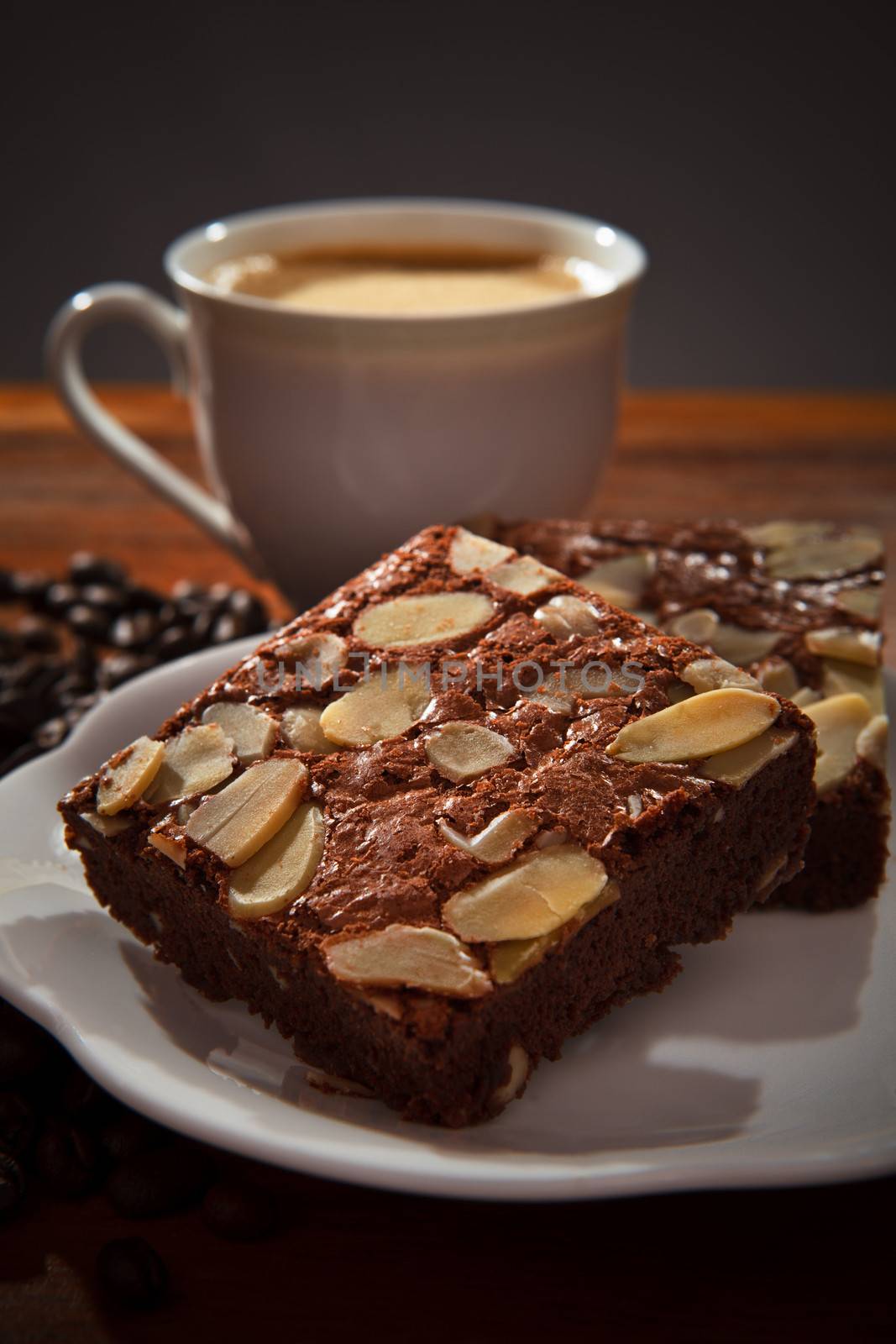 brownie cake and hot coffee on wood table