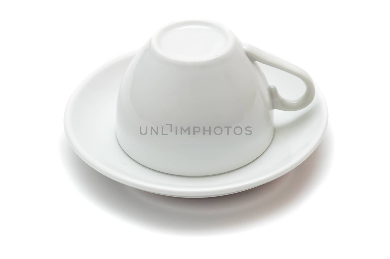 upside-down cup over saucer isolated on white background by mycola