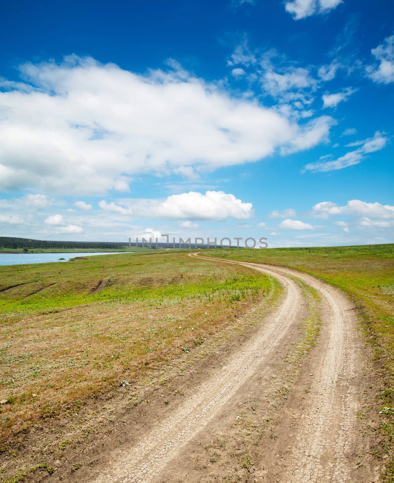 rural way under cloudy sky by mycola