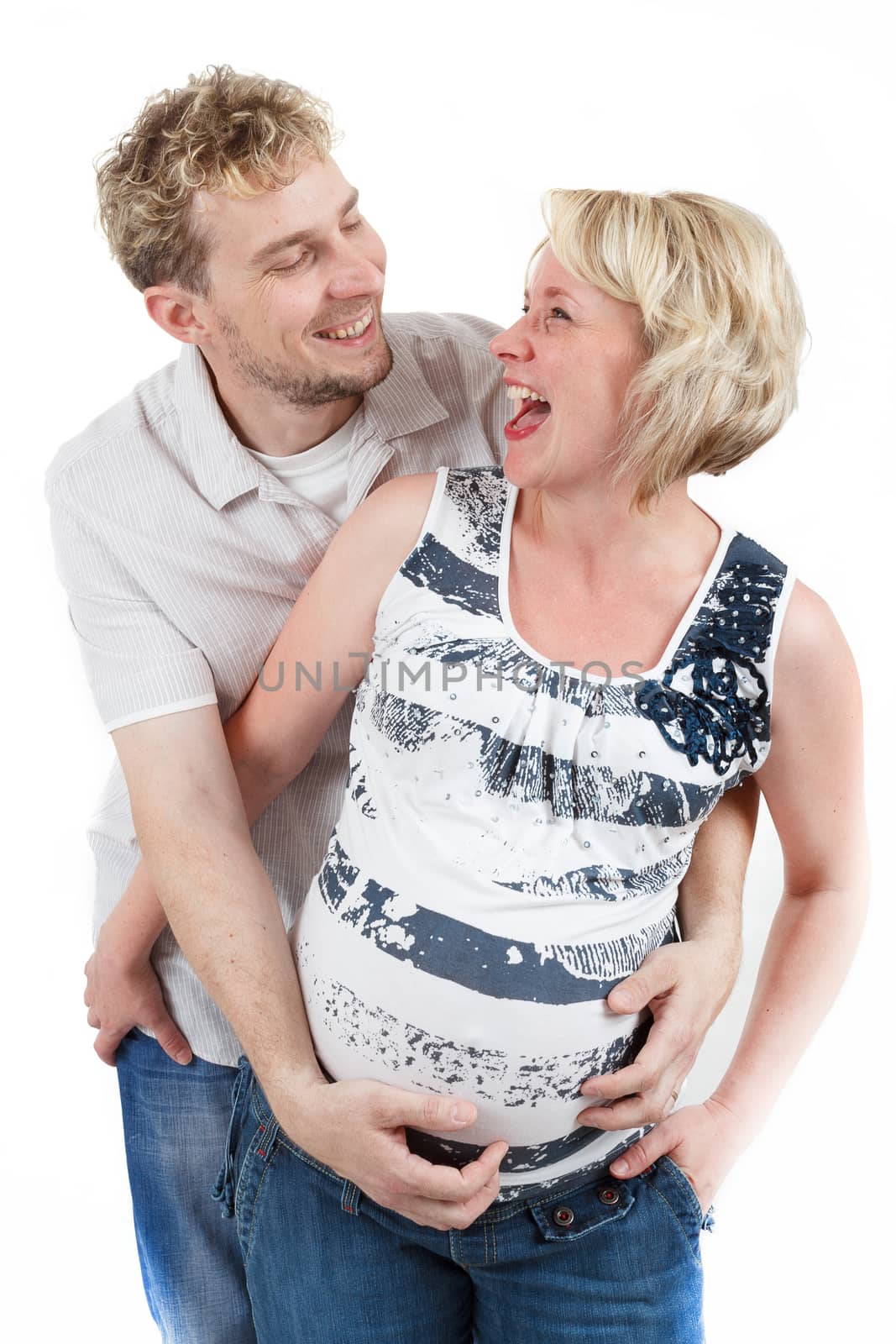 loving happy couple, smiling pregnant woman with her husband, isolated on white background, looking at each other