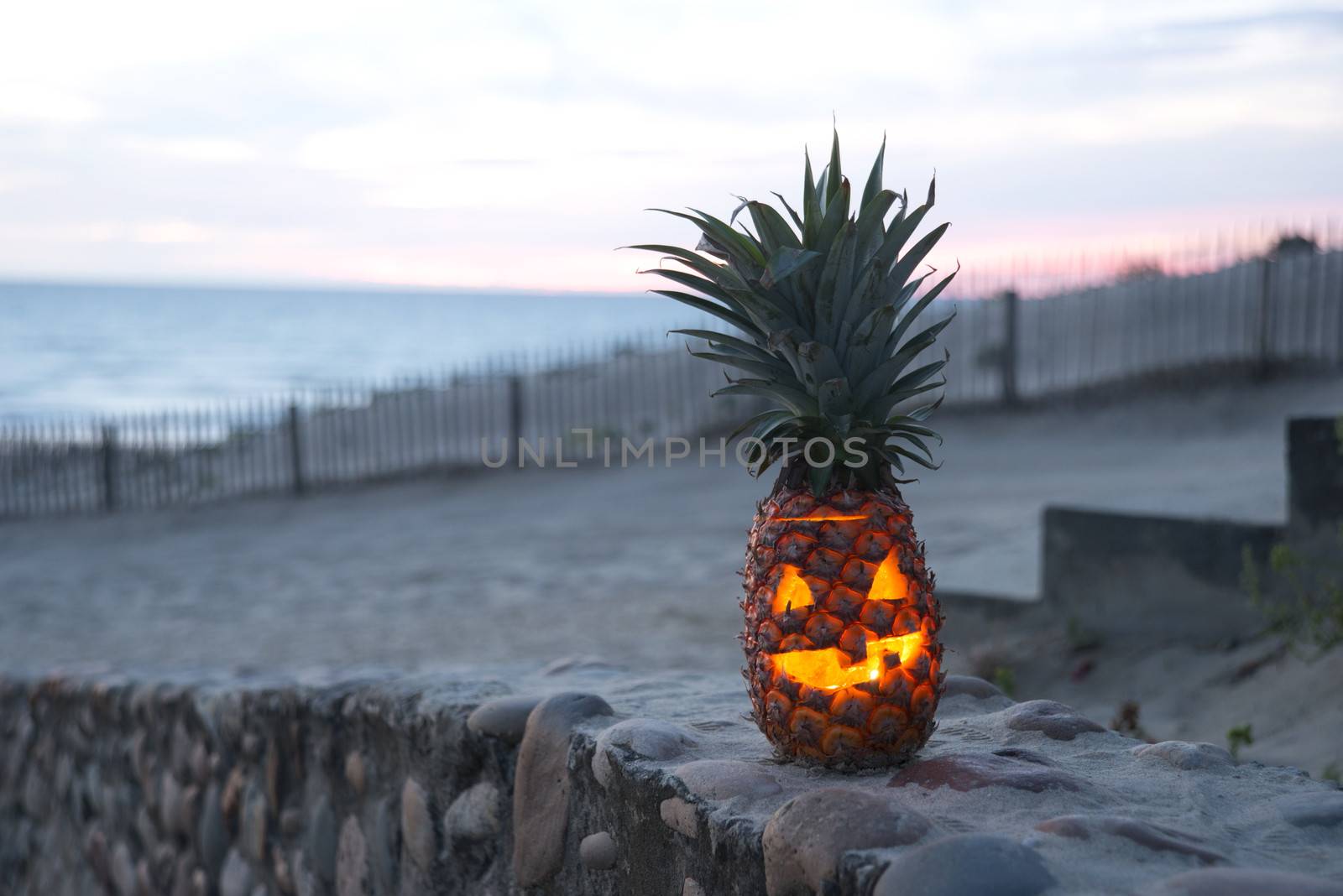 Tropical Halloween pineapple lantern on beach smiling