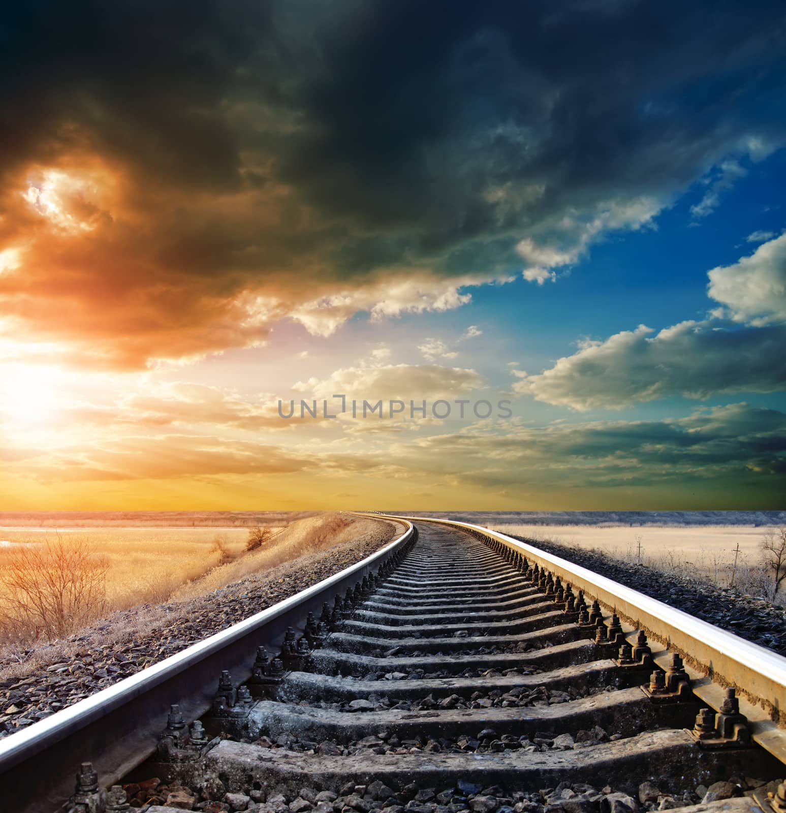 railway to horizon under dramatic sky