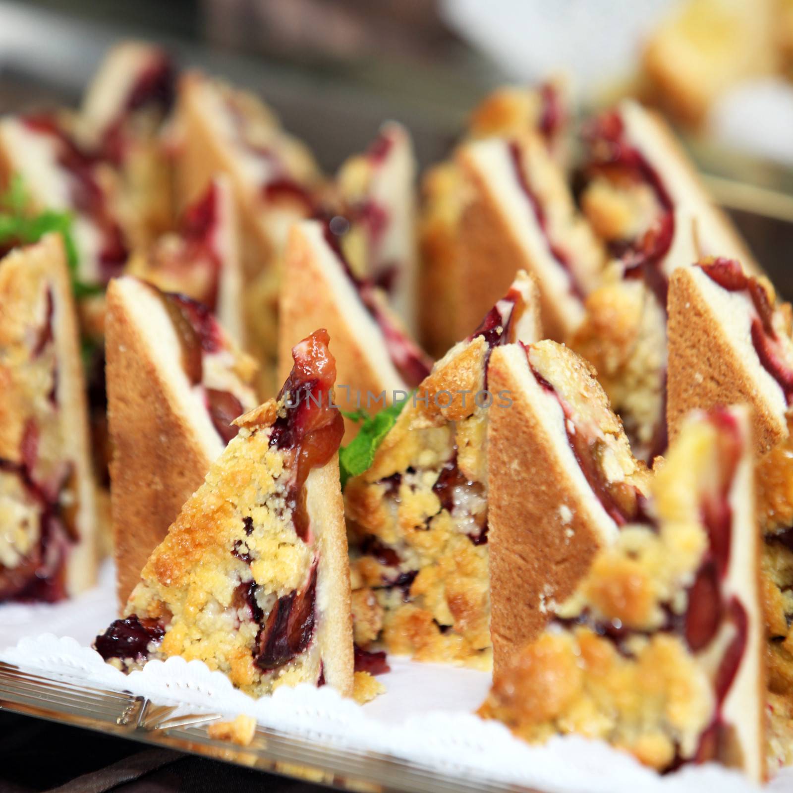 Close up of delicious freshly baked pastry and fruit desserts on a buffet table at a catered function or wedding reception