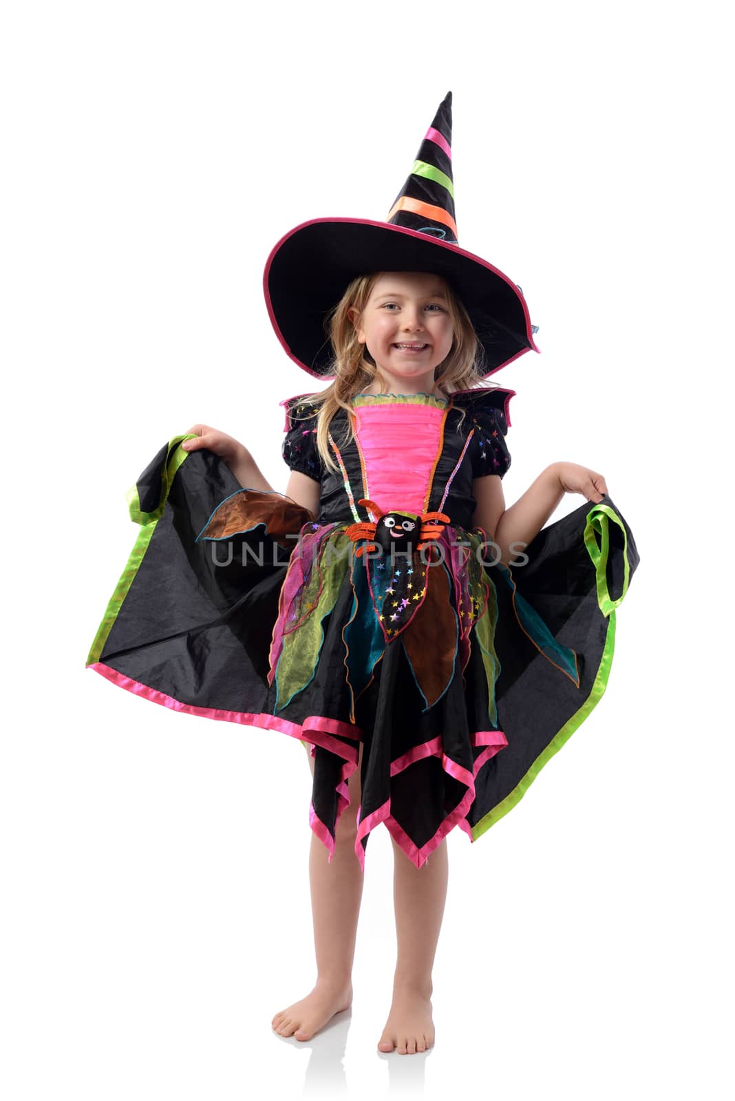 Little girl dressed up as a witch isolated on white