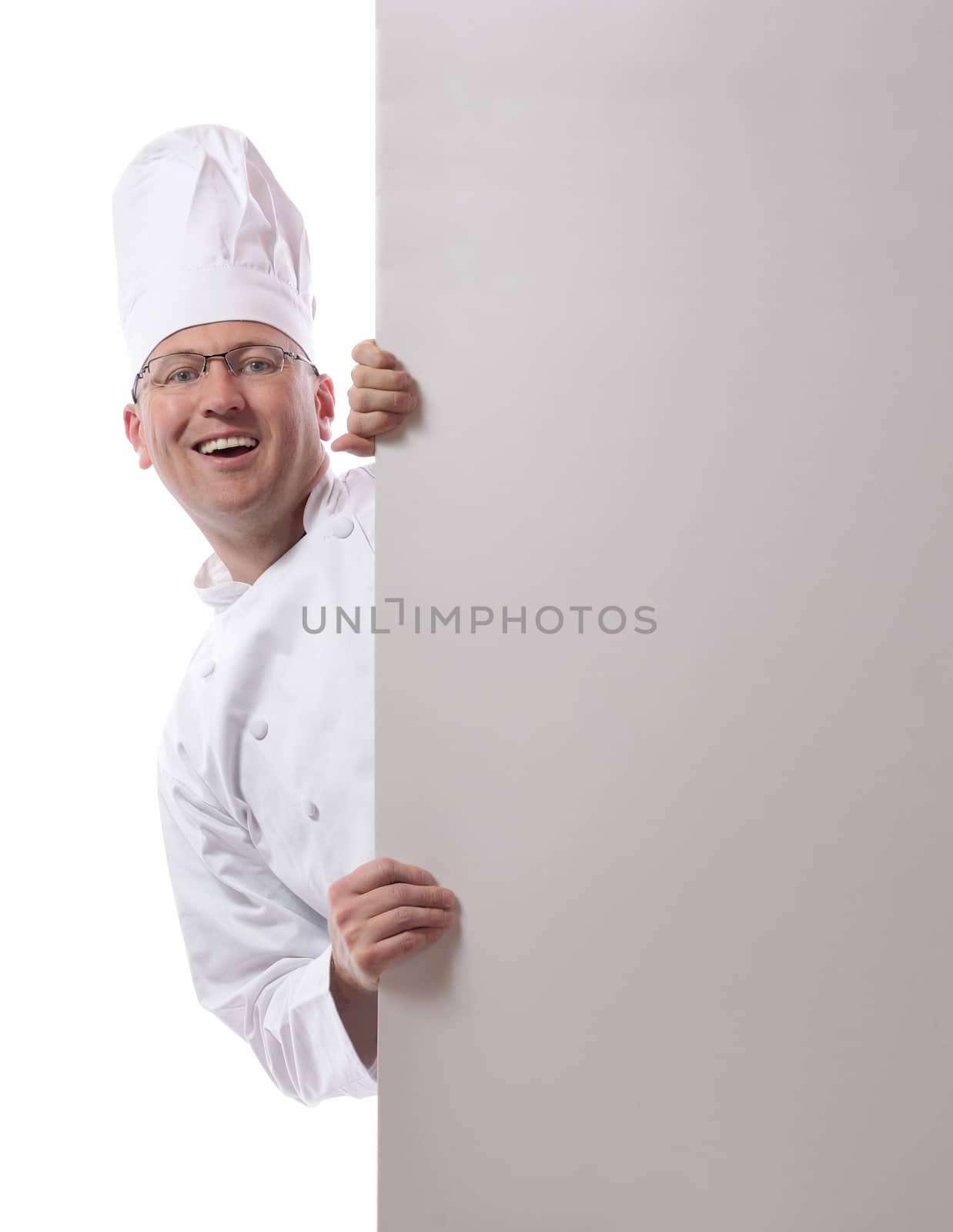 Male chef smiling from behind card isolated on white