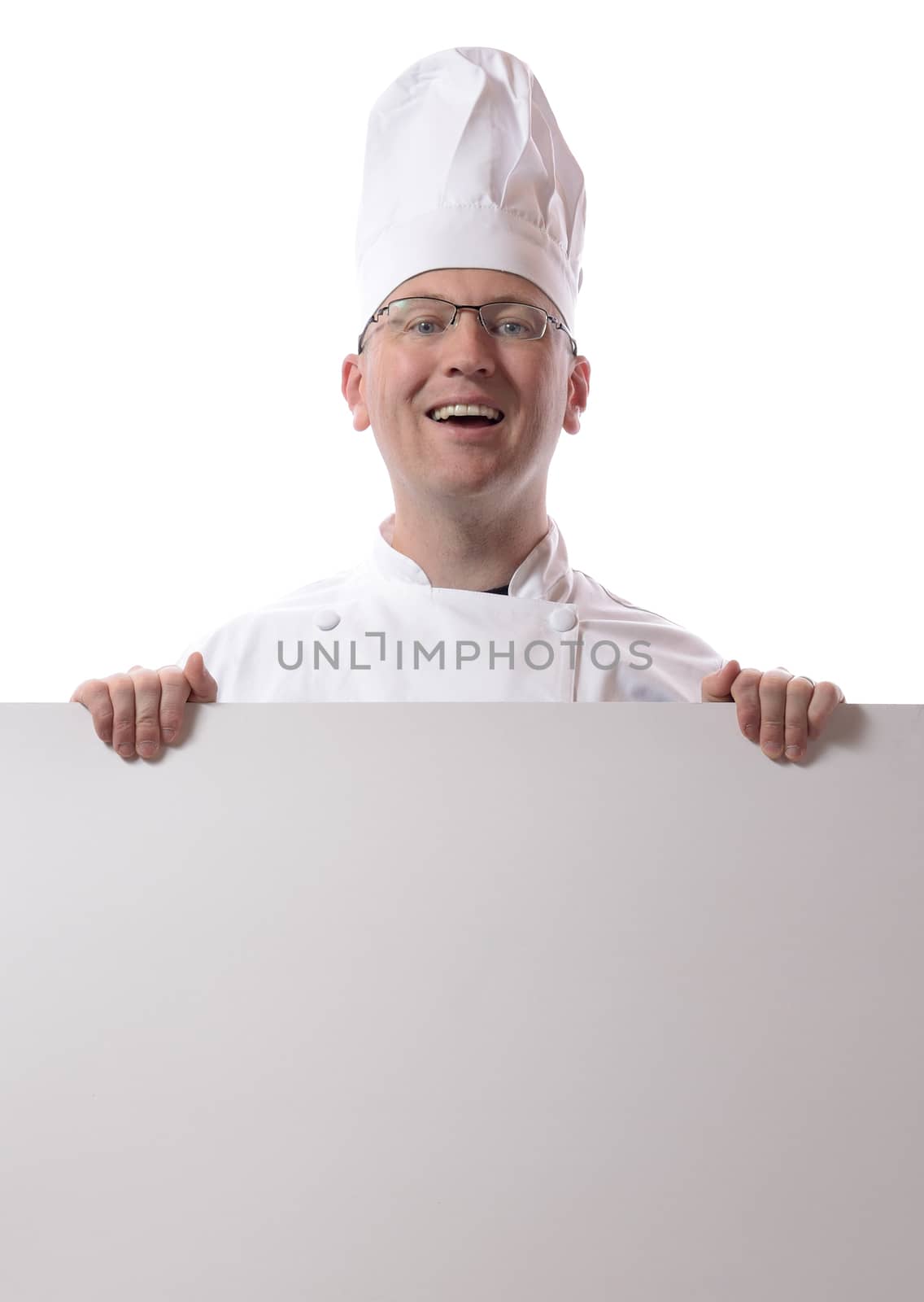 Male chef smiling from behind card isolated on white
