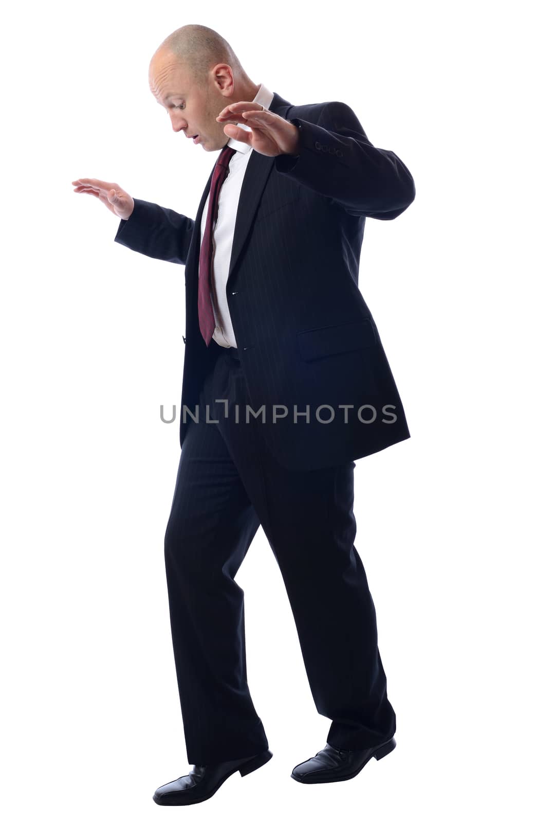 Balancing Businessman isolated on white concept of risky business