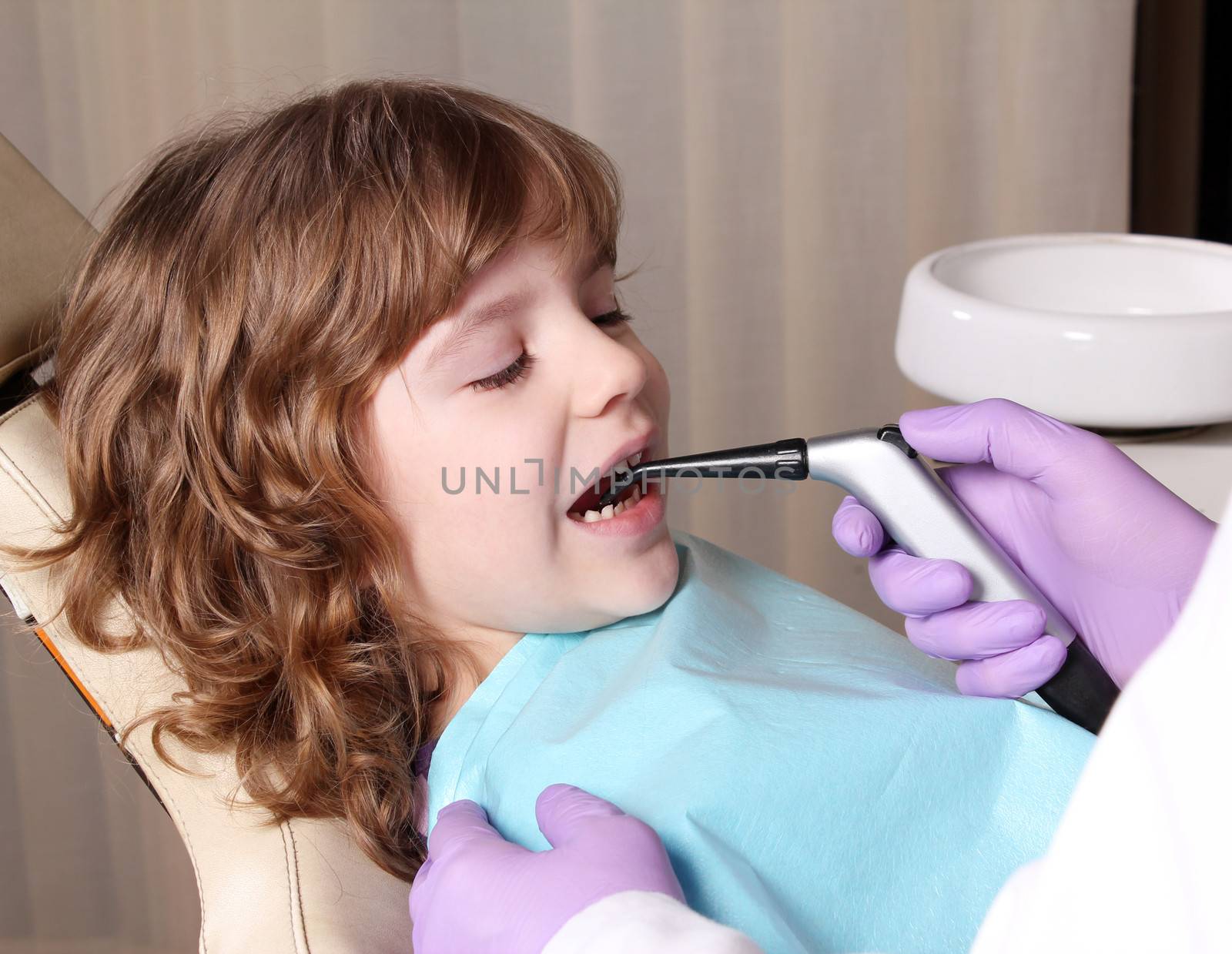 little girl patient in dental office by goce