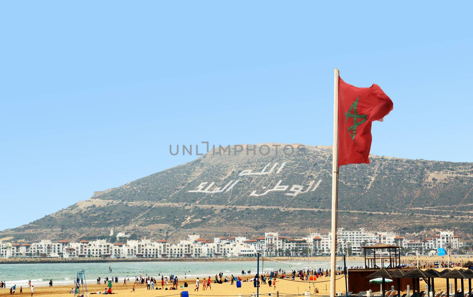 The beautiful beach in Agadir with flag of Morocco