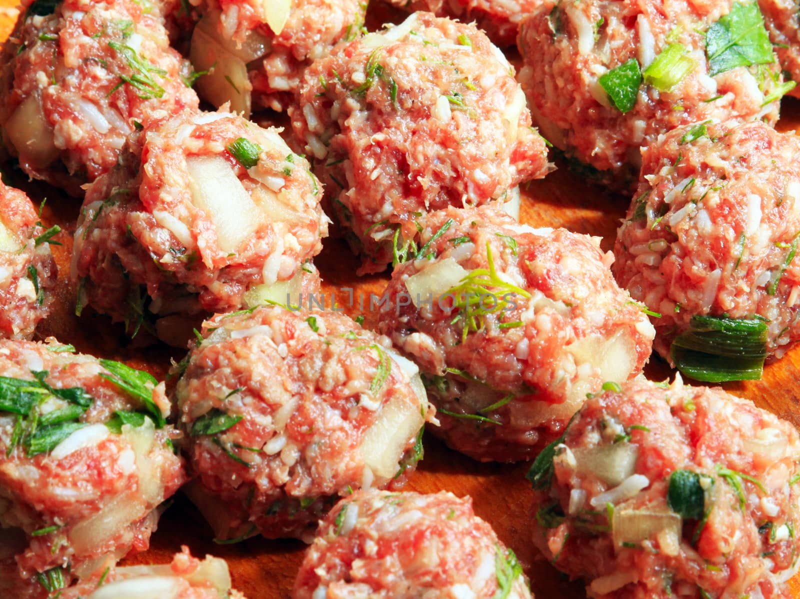 Raw meatballs on the chopping board
