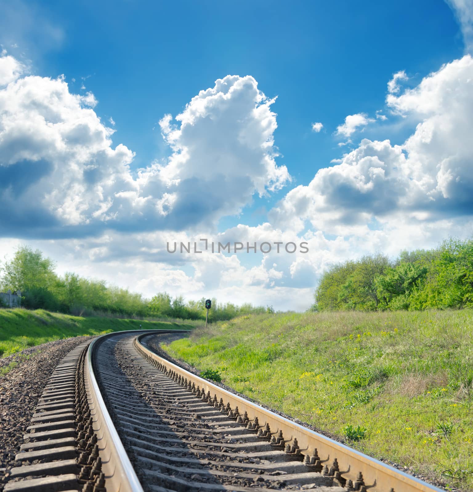 railway goes to horizon in green landscape