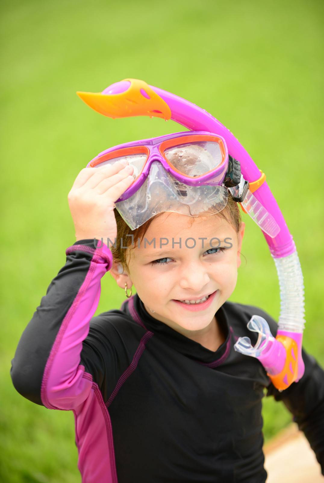 smiling young girl with swimming goggles and snorkel by ftlaudgirl