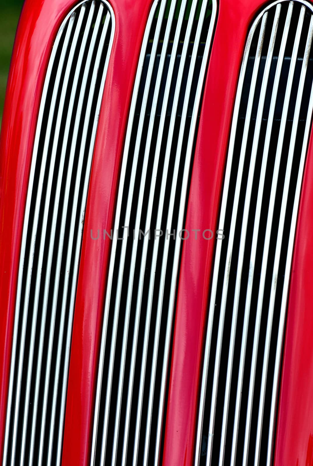 Red car radiator grill in portrait by pauws99
