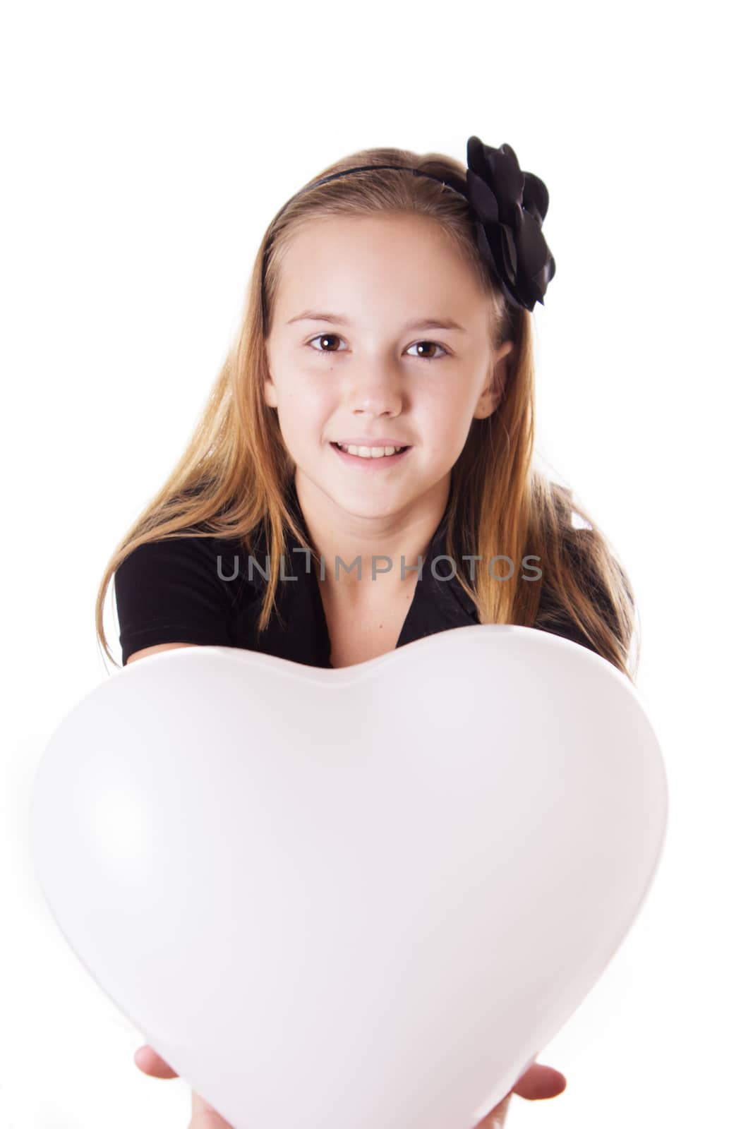 Cute girl holding heart shaped balloon isolated on white