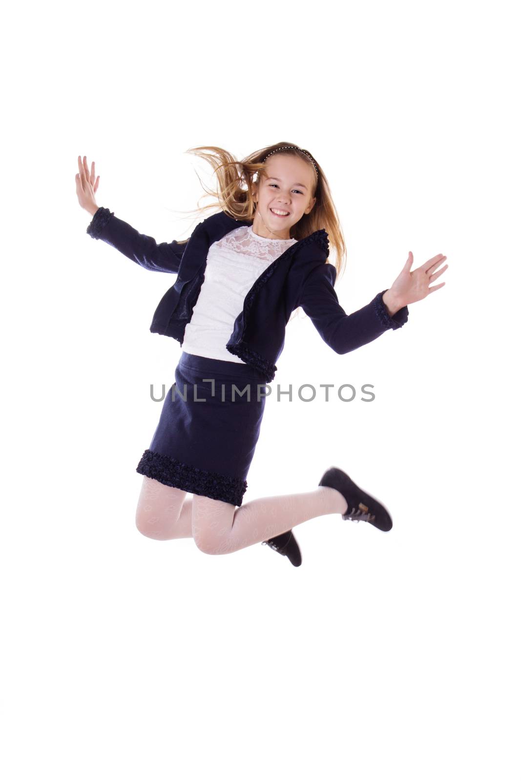 Happy schoolgirl in uniform jumping on white background, in motion