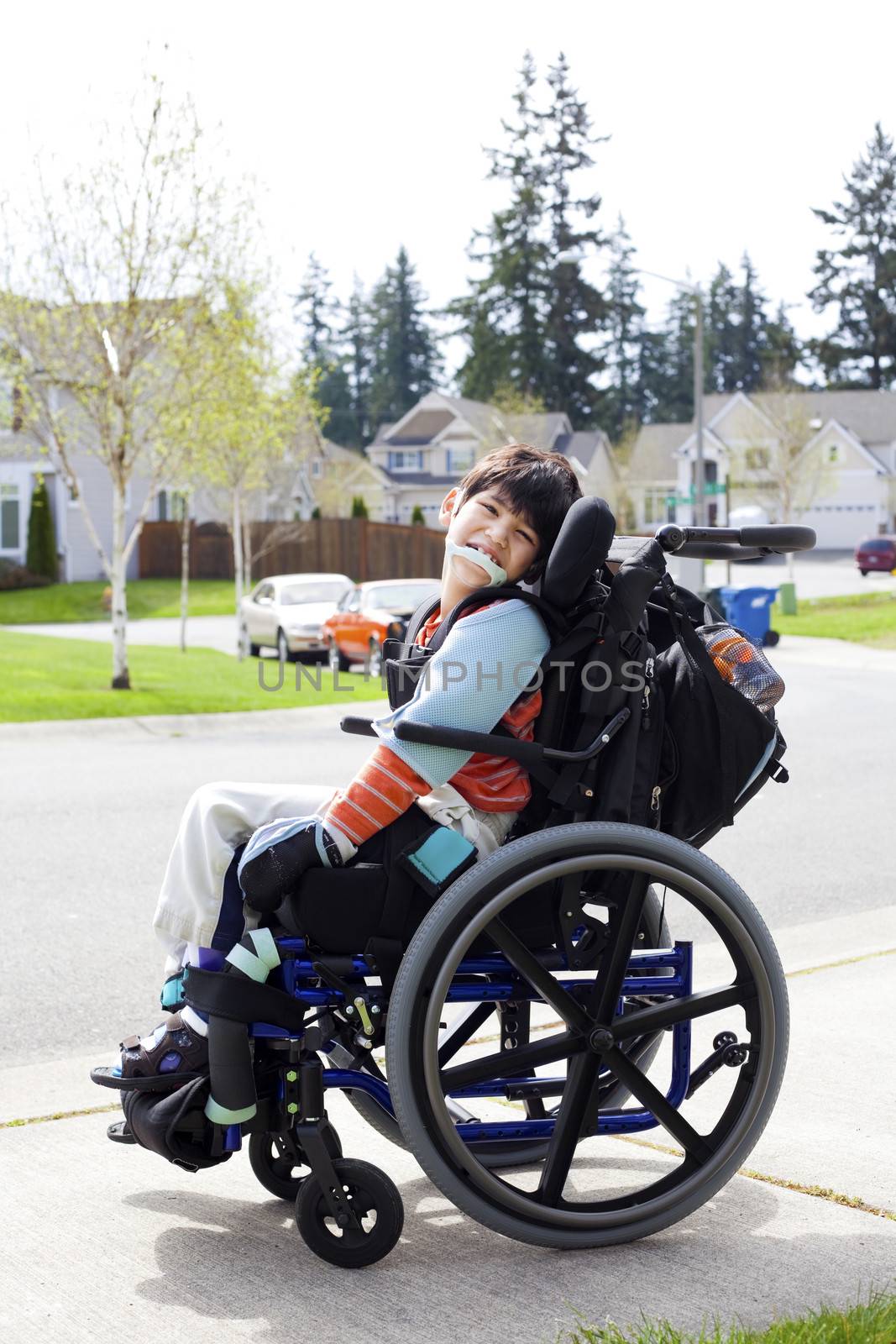 Happy little disabled boy in wheelchair by jarenwicklund
