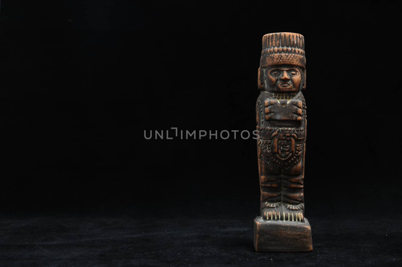 One Ancient Mayan Statue on a Black Background