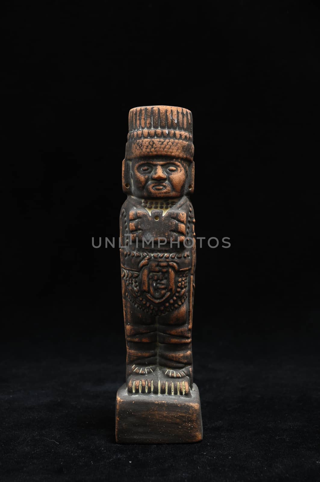 One Ancient Mayan Statue on a Black Background