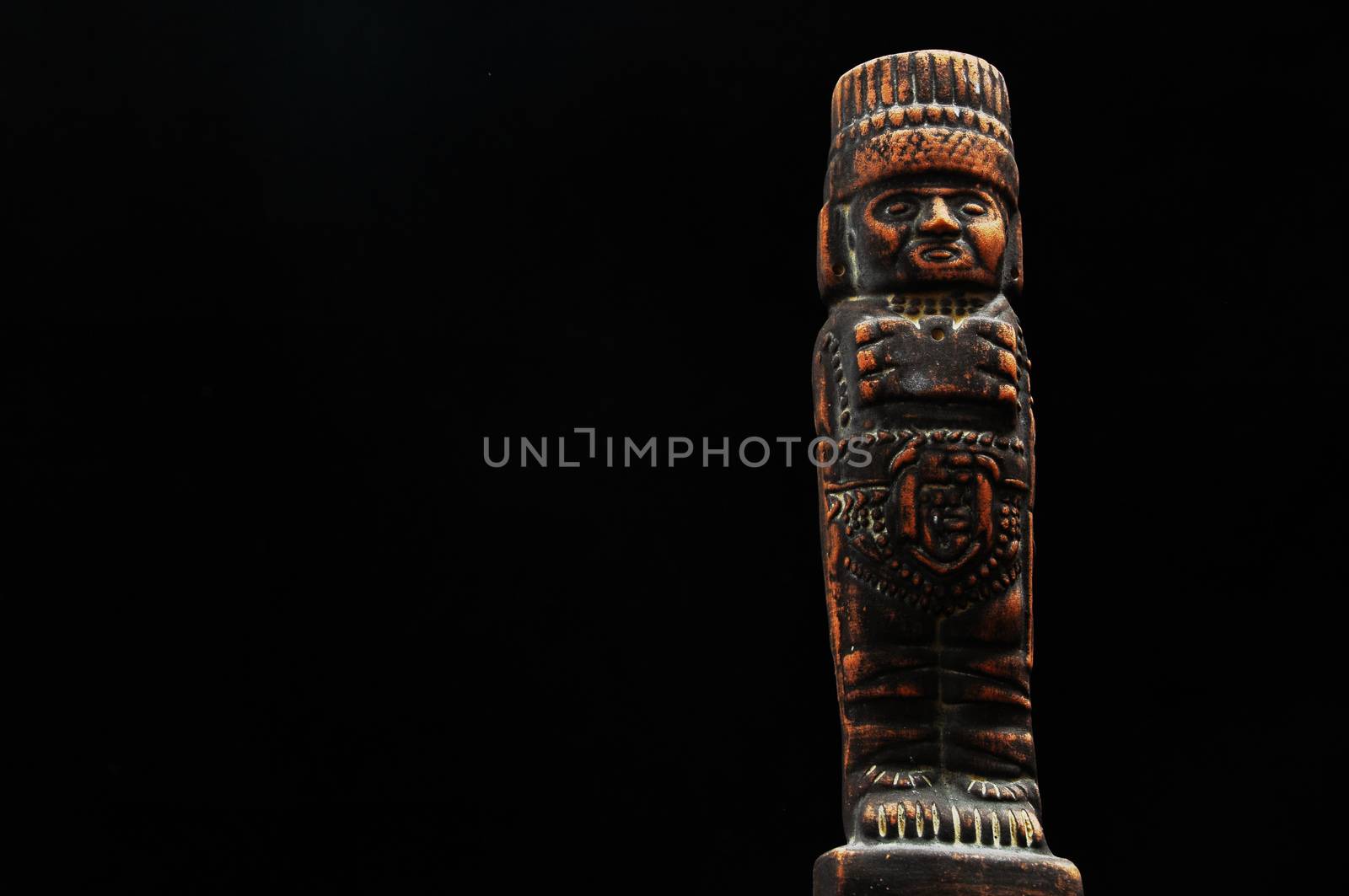 One Ancient Mayan Statue on a Black Background