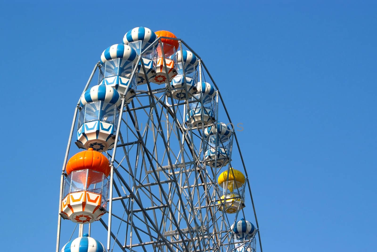 Colored Ferris wheel with blue sky background