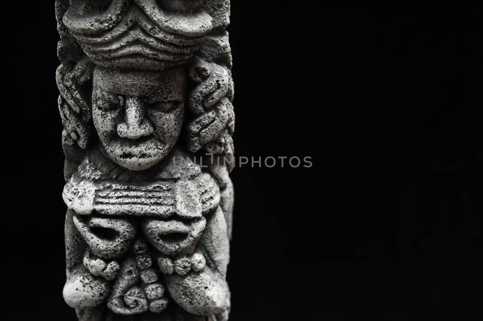 One Ancient Mayan Statue on a Black Background