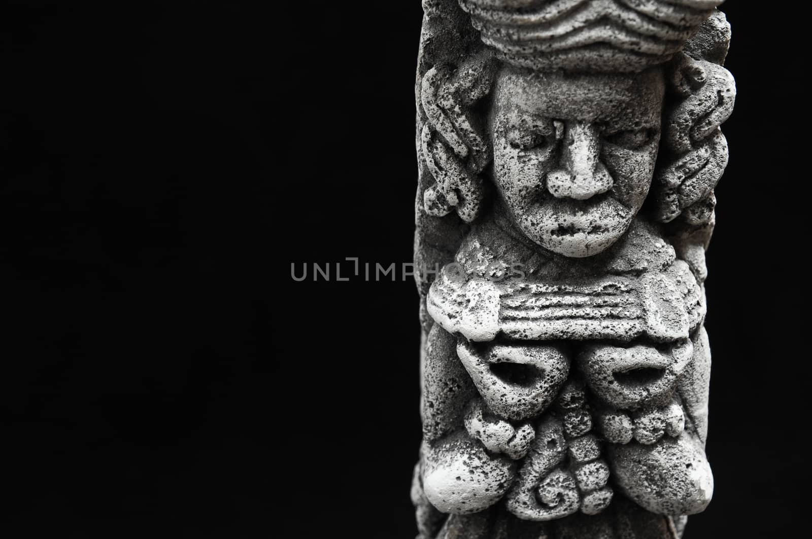 One Ancient Mayan Statue on a Black Background