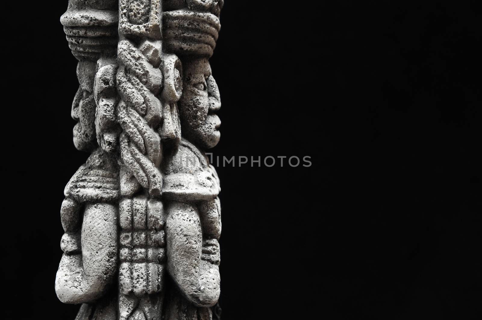 One Ancient Mayan Statue on a Black Background