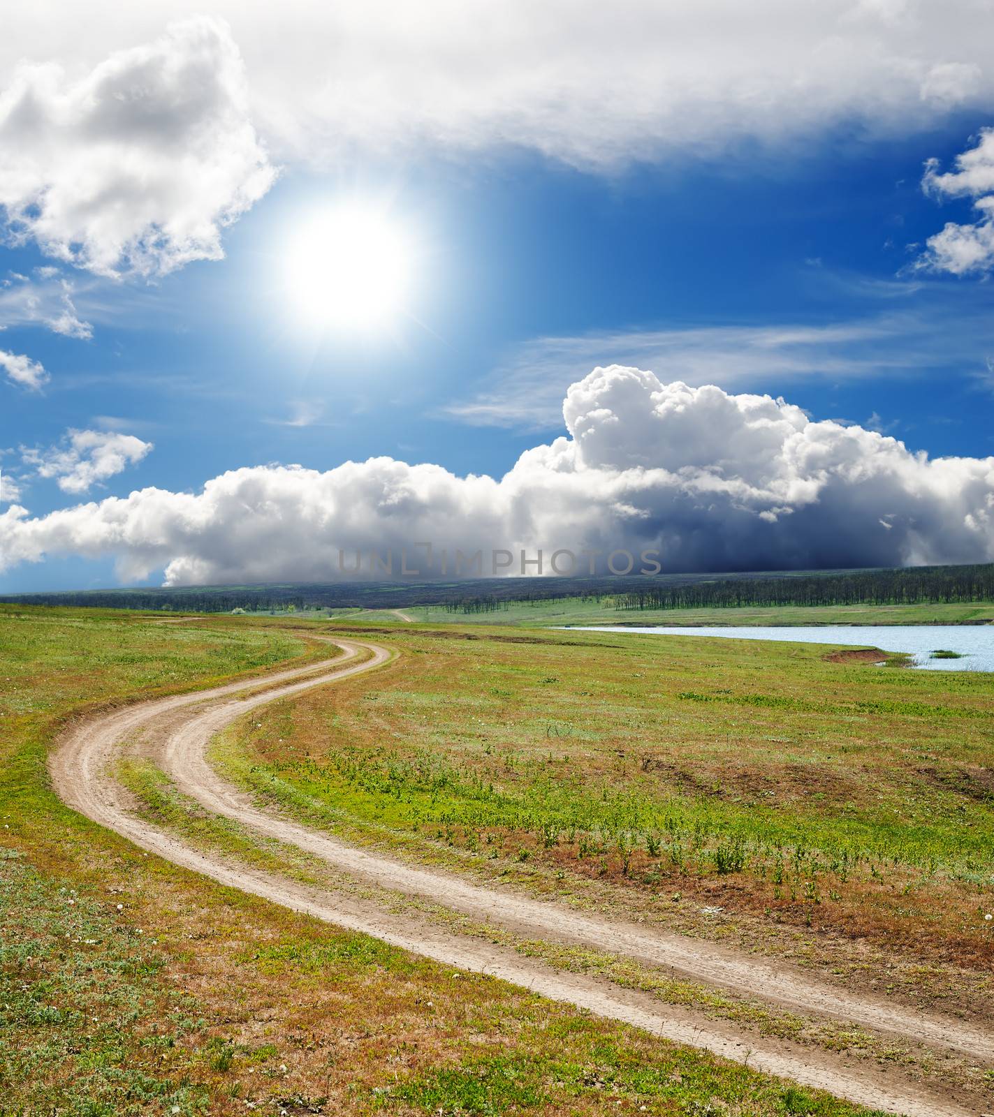 sun and clouds over dirty road by mycola