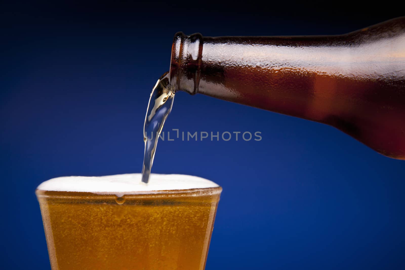 Beer is being poured in a glass.