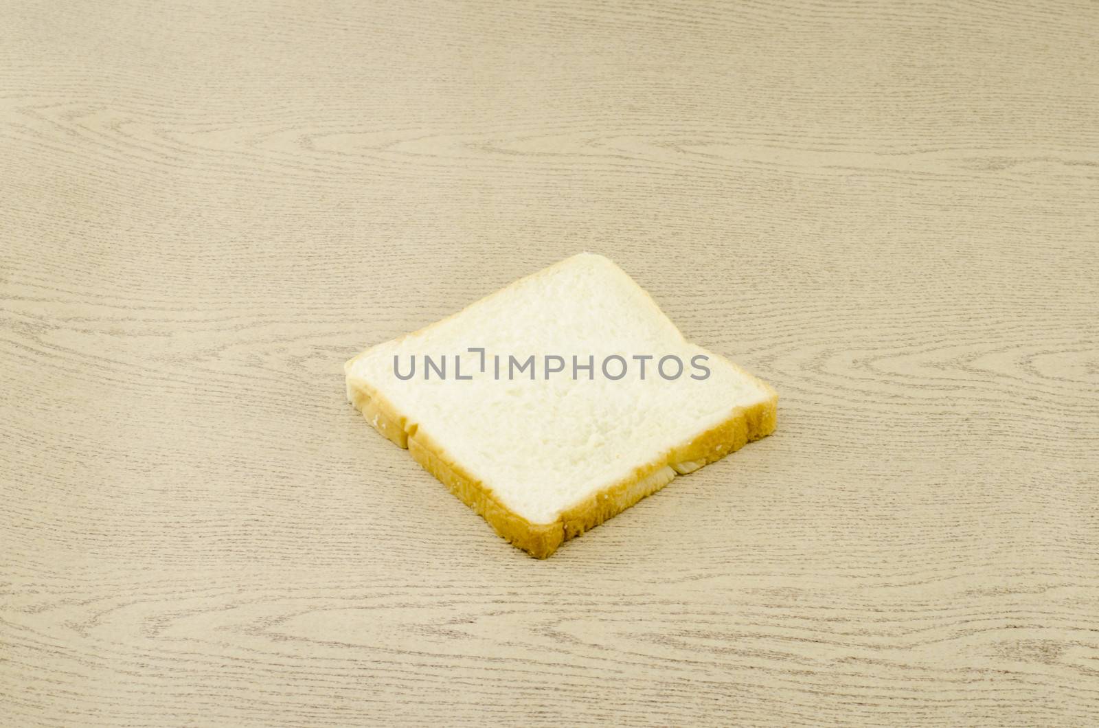 sliced bread on brown wood background