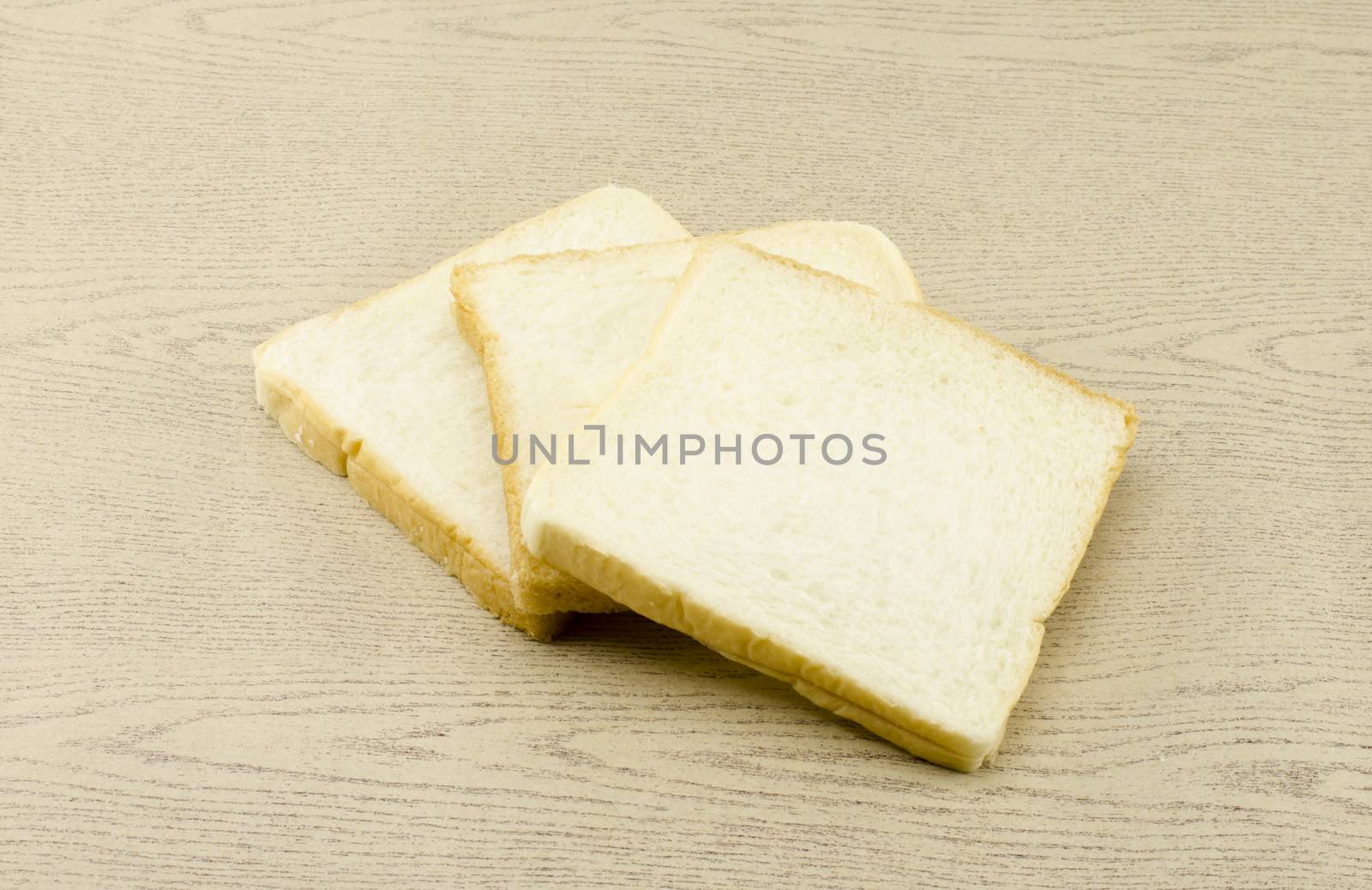 sliced bread on brown wood background