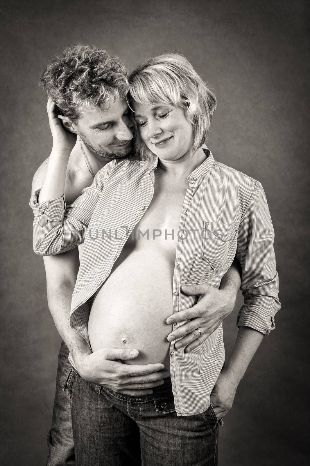 Loving happy couple, pregnant woman with her husband, black and white, romantic scene