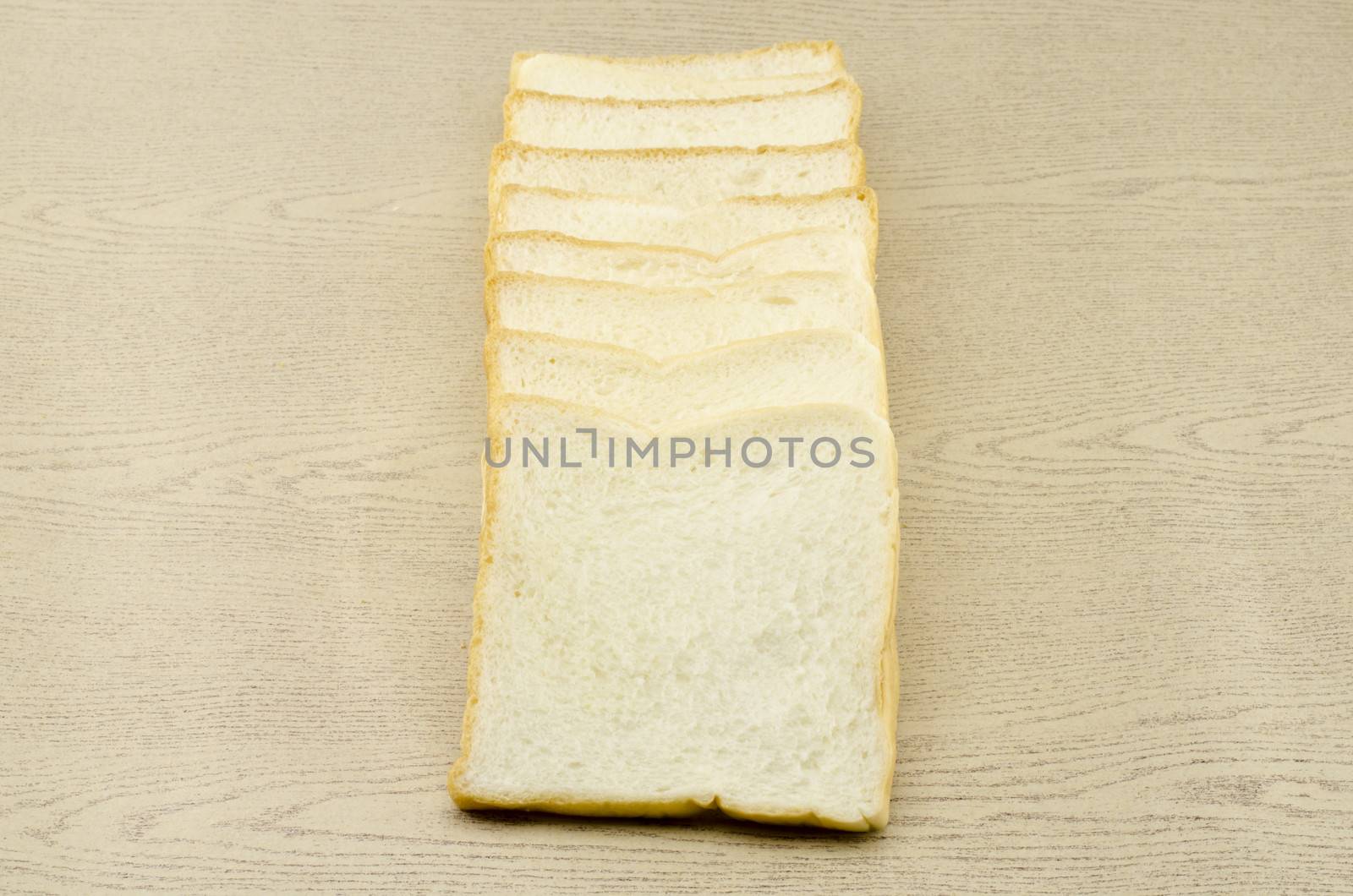 sliced bread on brown wood background