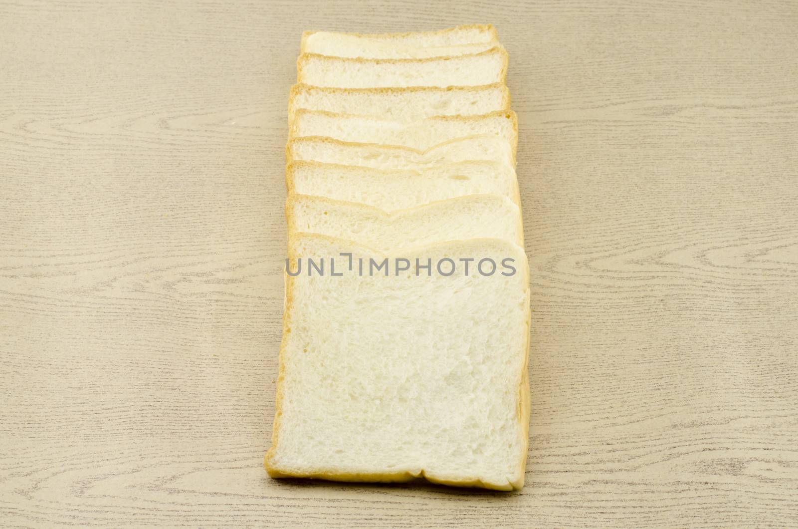 sliced bread on brown wood background