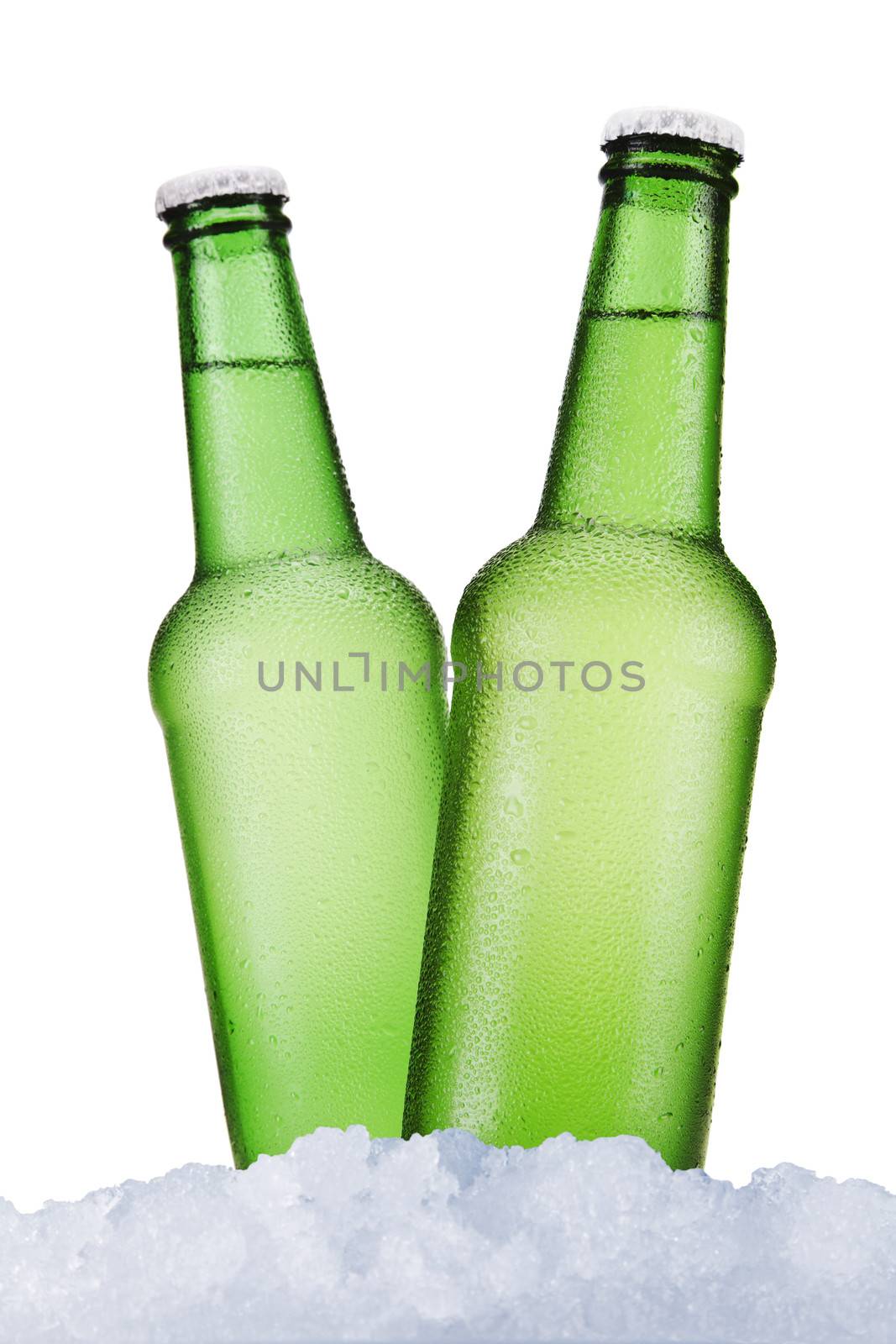 Three green beer bottles sitting on ice over a white background.
