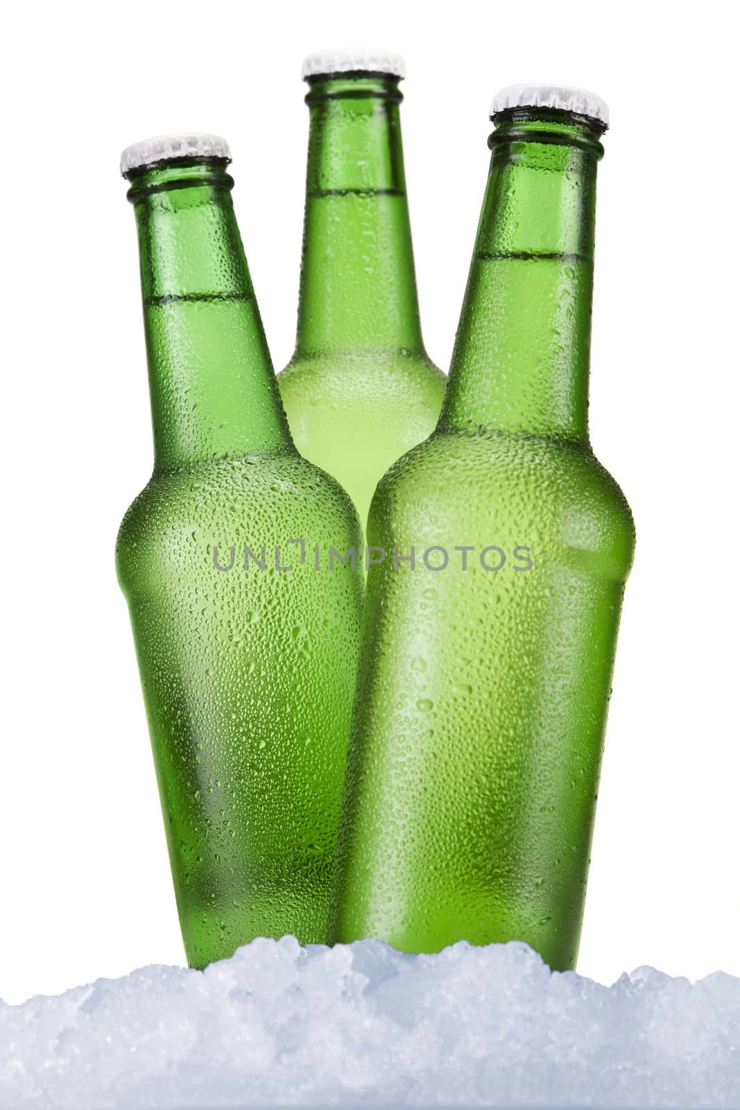 Three green beer bottles sitting on ice over a white background.